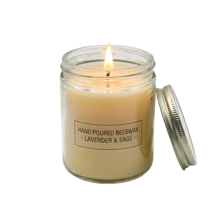 A glass jar with a candle inside of it.