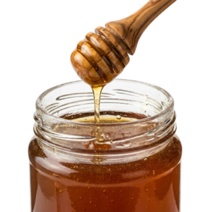 A jar of honey with a wooden spoon in it.