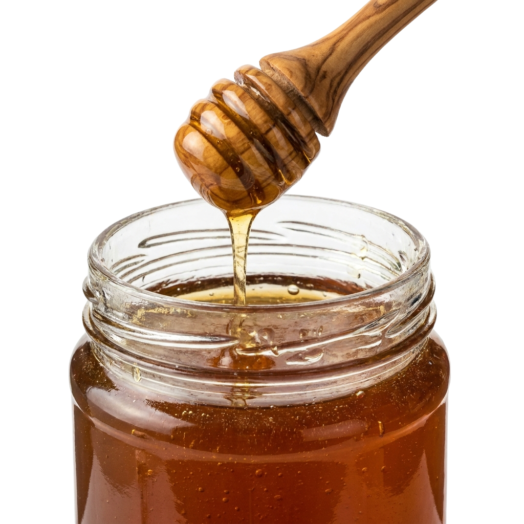 A jar of honey with a wooden spoon in it.