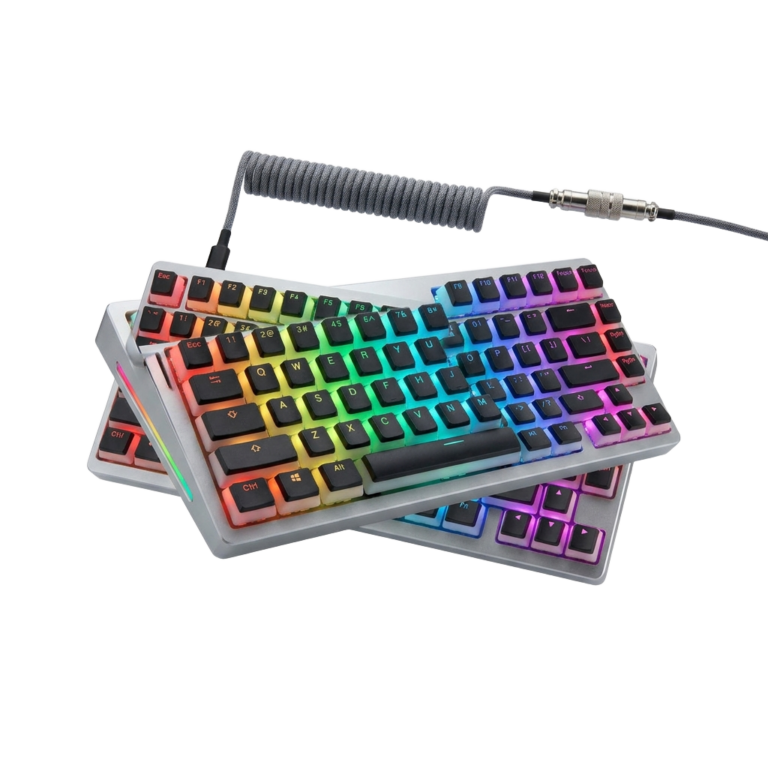 A pair of keyboards sitting next to each other on a white surface.