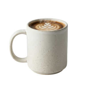 A white mug with a latte art design on it.