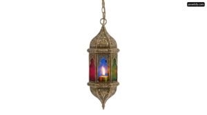 Brass lantern with a lit candle hanging from it png transparent background